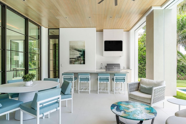 view of patio with an outdoor kitchen, sink, and grilling area