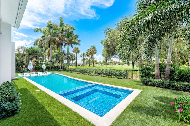 view of swimming pool featuring a lawn