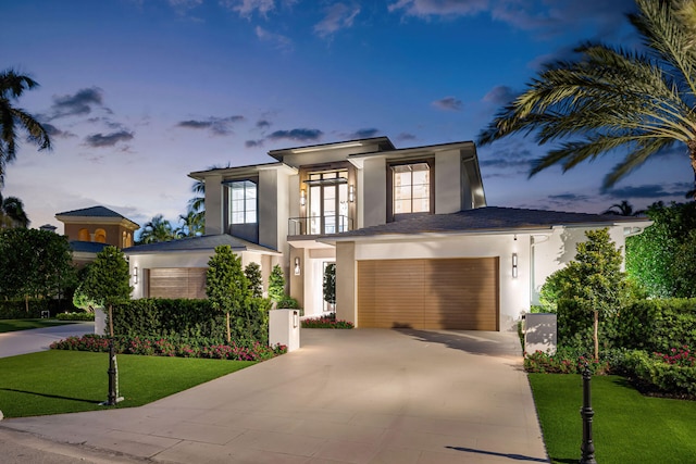 view of front of house featuring a garage and a lawn