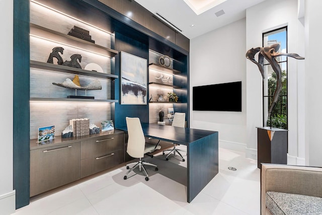 home office featuring light tile patterned floors and built in shelves