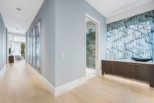 corridor with light hardwood / wood-style flooring