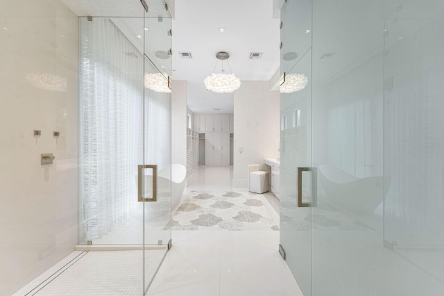 bathroom with a notable chandelier, tile patterned floors, and plus walk in shower