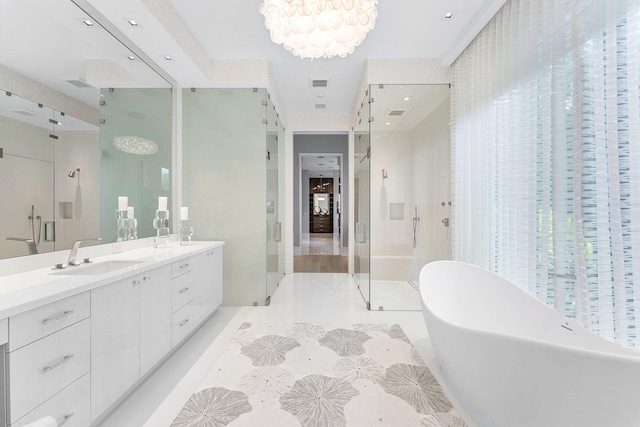 bathroom with tile patterned flooring, a chandelier, vanity, and independent shower and bath