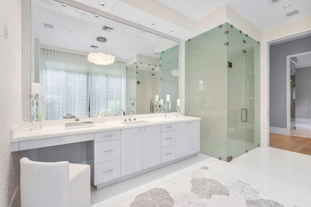 bathroom featuring an enclosed shower, vanity, and tile patterned flooring