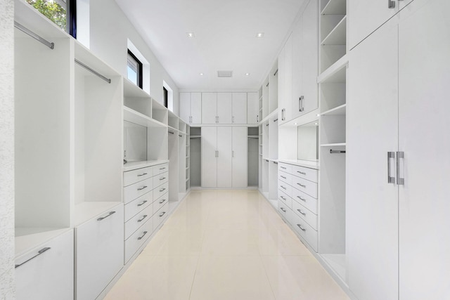 spacious closet with light tile patterned floors