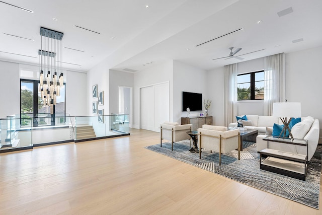 living room featuring ceiling fan and light wood-type flooring