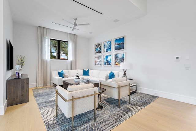 living room with ceiling fan and wood-type flooring