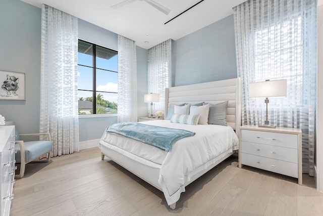 bedroom with ceiling fan and light hardwood / wood-style floors