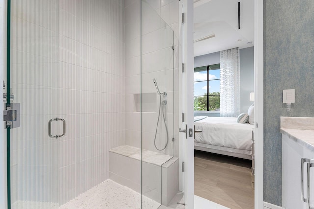 bathroom with wood-type flooring, an enclosed shower, and vanity