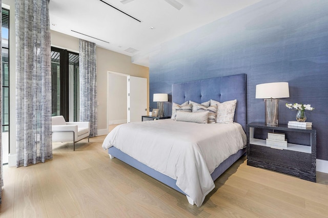 bedroom with ceiling fan and light hardwood / wood-style floors