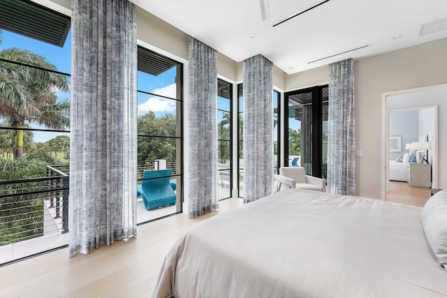 bedroom featuring access to outside and light hardwood / wood-style floors