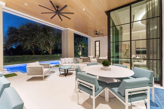 view of patio with ceiling fan, a fenced in pool, and an outdoor living space