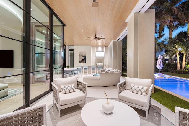 sunroom with ceiling fan, wood ceiling, and a swimming pool