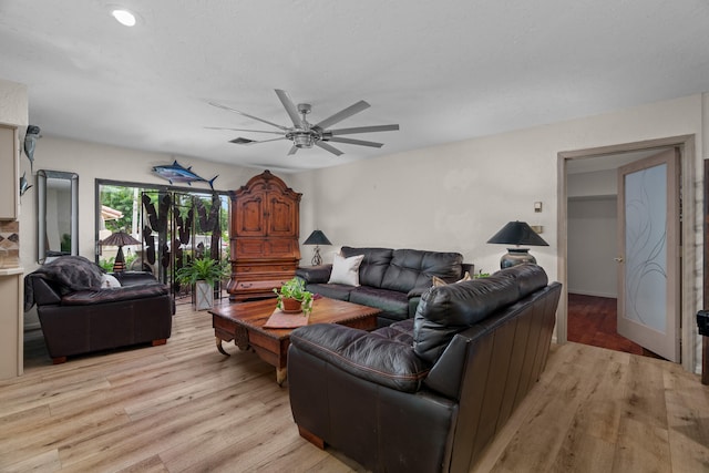 living room with ceiling fan and light hardwood / wood-style floors