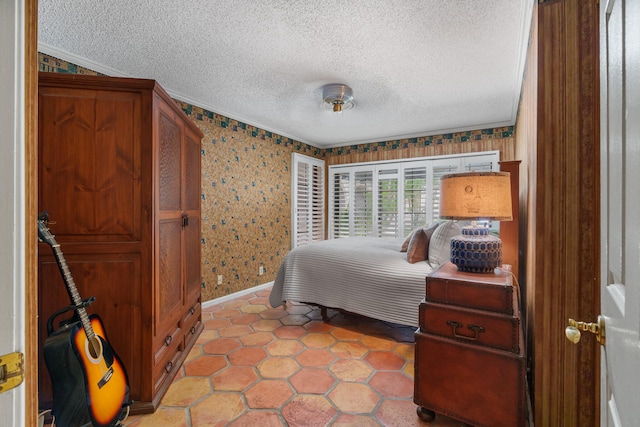 bedroom with ornamental molding and a textured ceiling