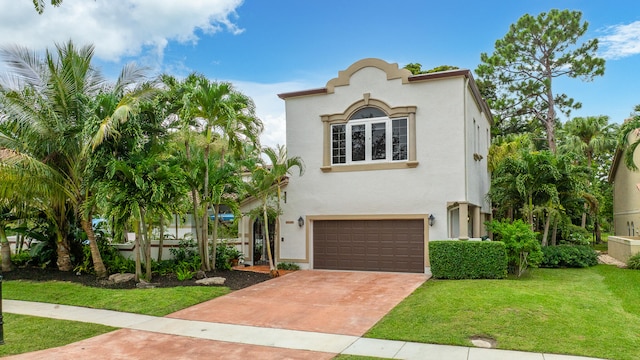 mediterranean / spanish-style house featuring a front yard and a garage