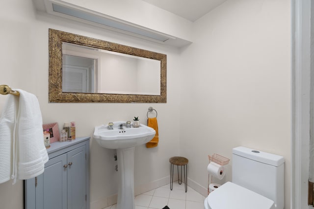 bathroom featuring toilet, sink, and tile patterned floors