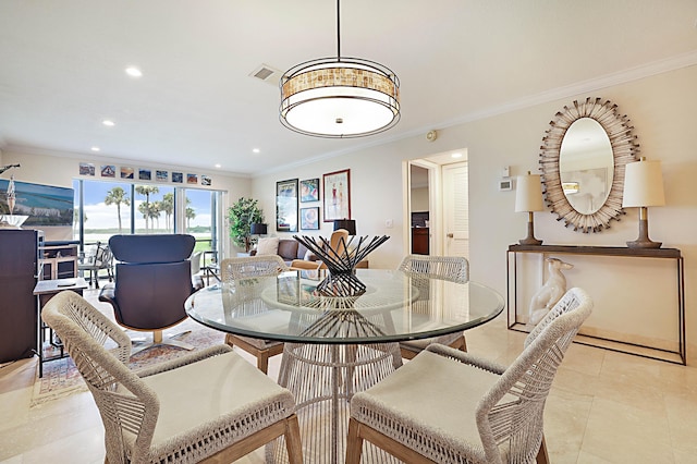 dining space with ornamental molding