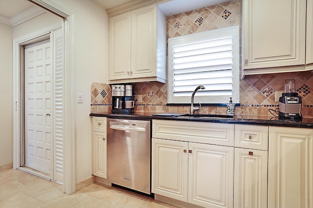 kitchen with sink, decorative backsplash, cream cabinets, and dishwasher