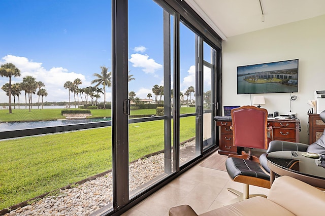 sunroom featuring a water view