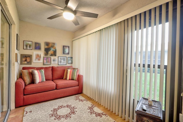 sitting room featuring ceiling fan and a textured ceiling