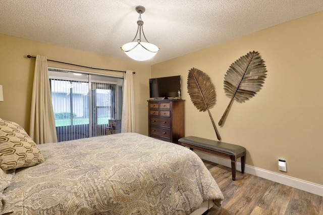 bedroom with hardwood / wood-style flooring and a textured ceiling