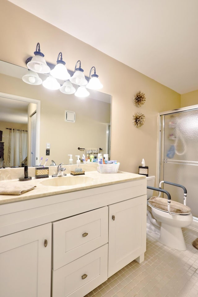 bathroom with tile patterned floors, vanity, toilet, and walk in shower