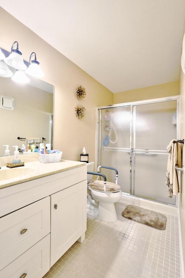 bathroom with tile patterned flooring, vanity, toilet, and walk in shower