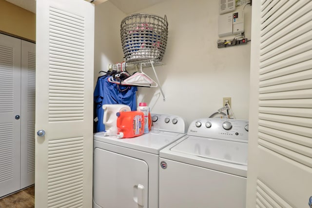 washroom featuring dark hardwood / wood-style flooring and washing machine and dryer