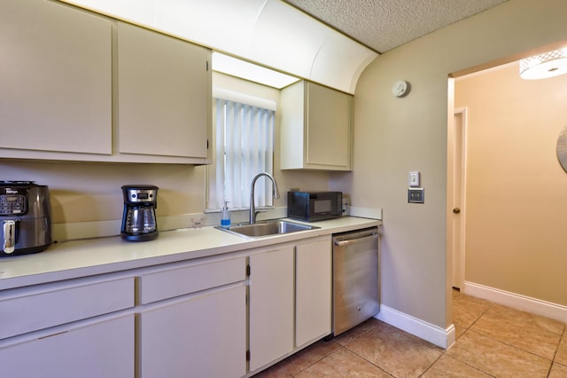 kitchen with dishwasher, light tile patterned floors, a textured ceiling, and sink