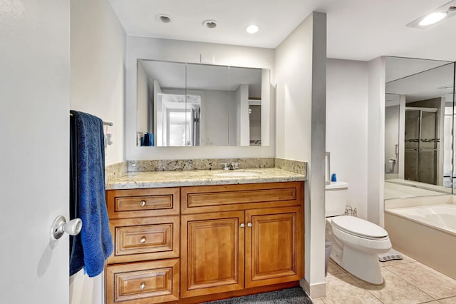 full bathroom with toilet, vanity, tile patterned floors, and independent shower and bath