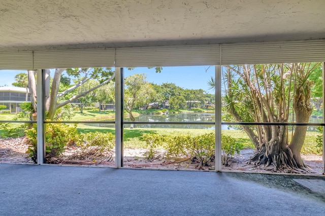 unfurnished sunroom with a water view