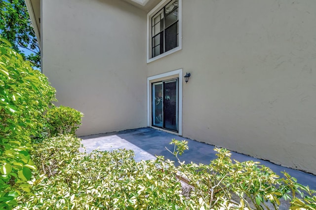 entrance to property featuring a patio area