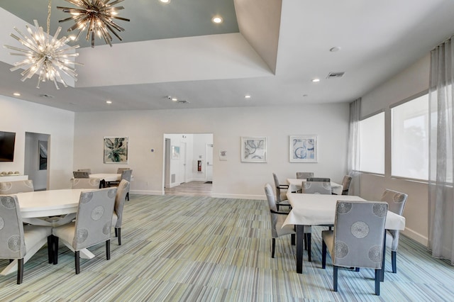 carpeted dining area featuring an inviting chandelier