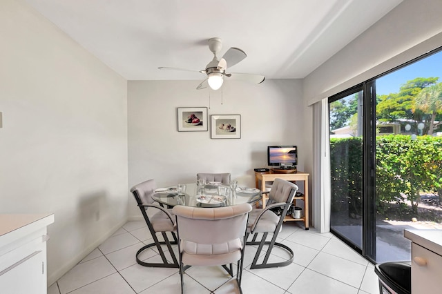 dining space featuring light tile patterned flooring and ceiling fan