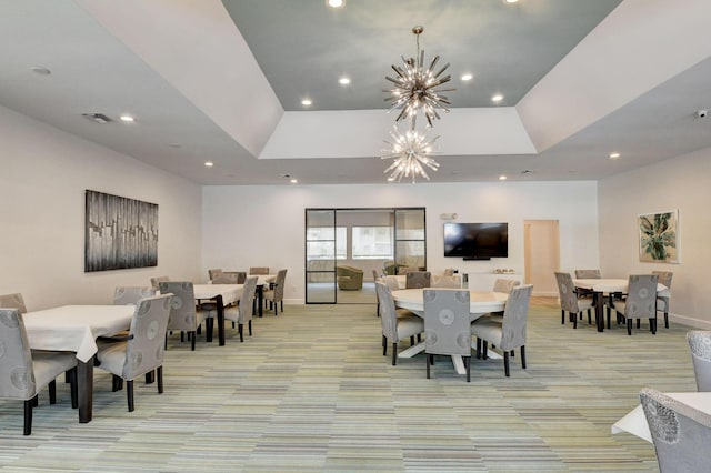 dining room with light colored carpet and a chandelier