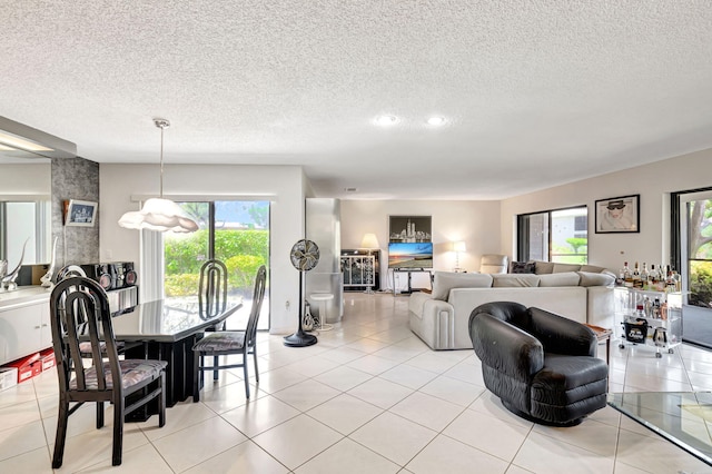 dining area with a textured ceiling and light tile patterned floors