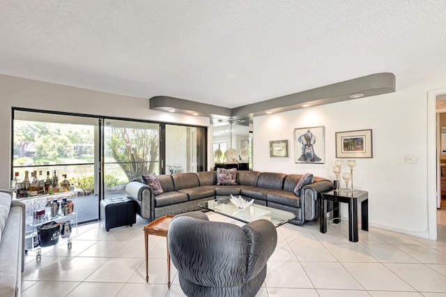 living room with a textured ceiling and light tile patterned floors