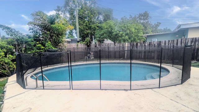 view of swimming pool featuring a fenced in pool and fence