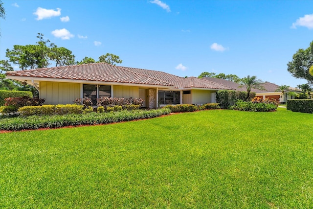 ranch-style house with a front lawn