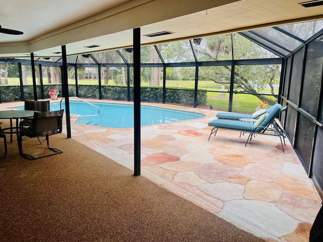 view of swimming pool featuring a patio, ceiling fan, and a lanai