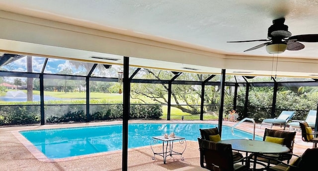 view of pool with a lanai, ceiling fan, and a patio