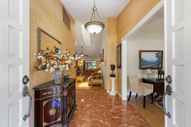 foyer with dark hardwood / wood-style flooring and ceiling fan