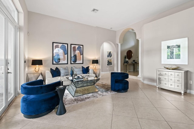 tiled living room featuring decorative columns