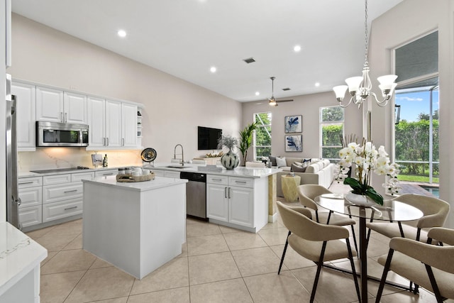 kitchen featuring white cabinetry, appliances with stainless steel finishes, pendant lighting, and kitchen peninsula