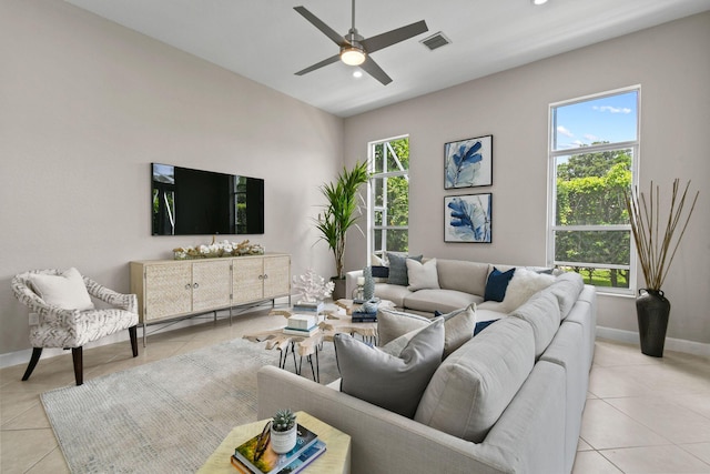 tiled living room with a baseboard heating unit, a wealth of natural light, and ceiling fan