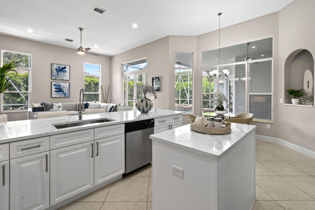 kitchen featuring sink, white cabinetry, dishwasher, a kitchen island, and pendant lighting