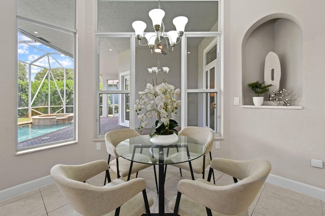 tiled dining space featuring an inviting chandelier