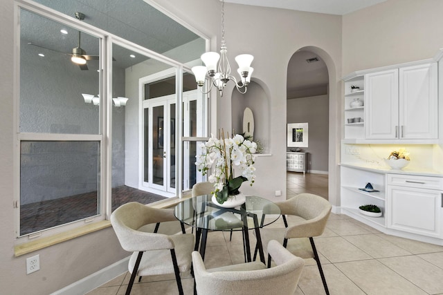 dining space with a notable chandelier and light tile patterned flooring