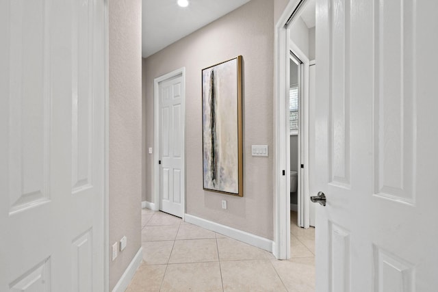 corridor with light tile patterned floors